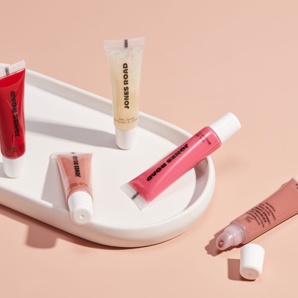 Several shades of Jones Road Beauty Cool Gloss displayed on a ceramic tray