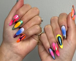 A mismatched manicure with chrome, airbrush, and ombre details